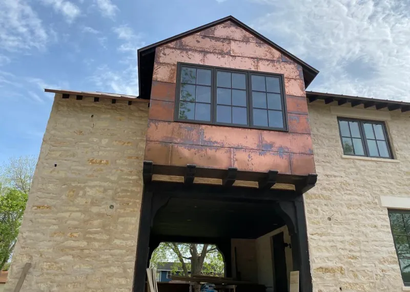 Copper metal panel facade on a stone building for Metal Roof Coating in Wilna