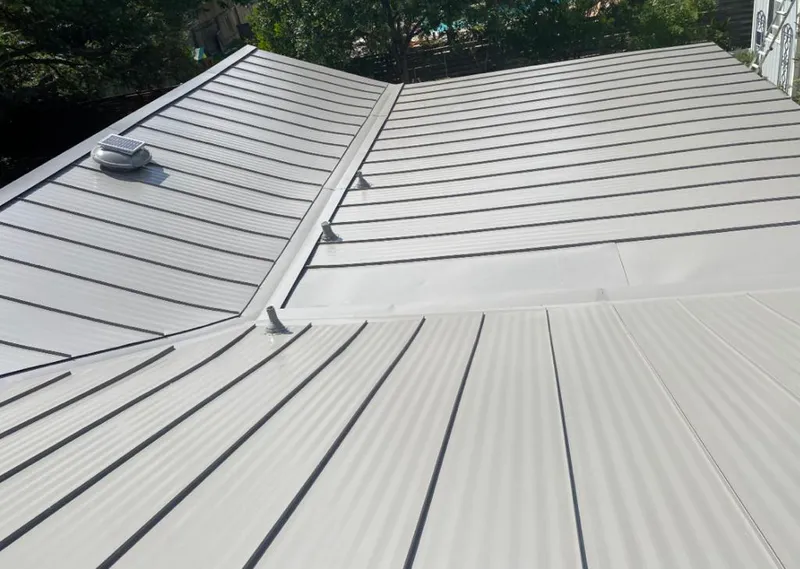 Solar attic fan installed on a metal roof for Roof Ventilation in Wilna